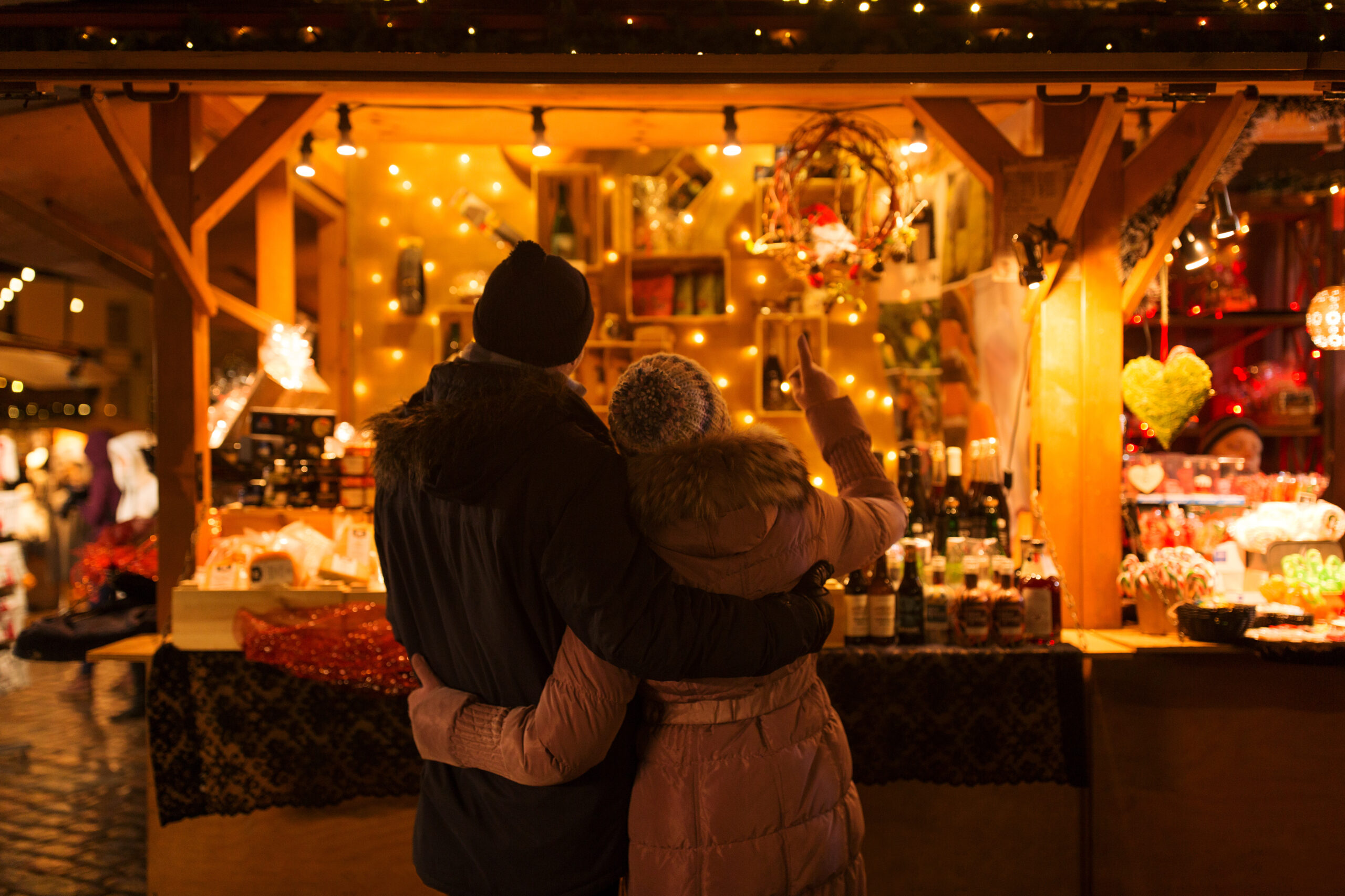 happy senior couple hugging at christmas market